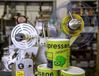 Espressone nutzt den halbautomatischen Etikettenspender Geset 141 zur schnellen und präzisen Kennzeichnung seiner Kaffeedosen